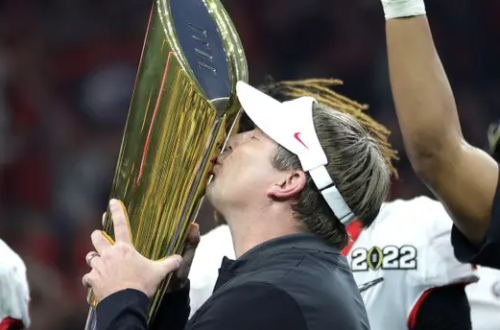 Kirby Smart, Head Coach of the Georgia Bulldogs, holding up the National Championship trophy