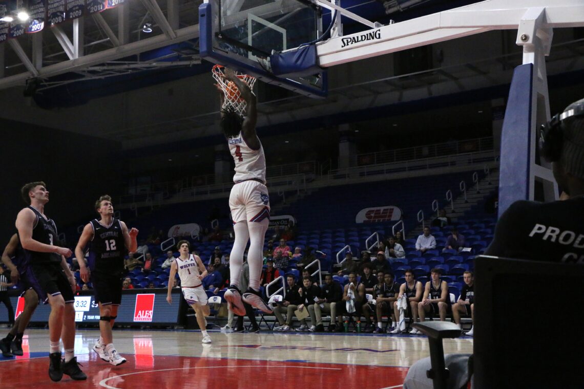 UWG player Williams-Dryden dunking basketball